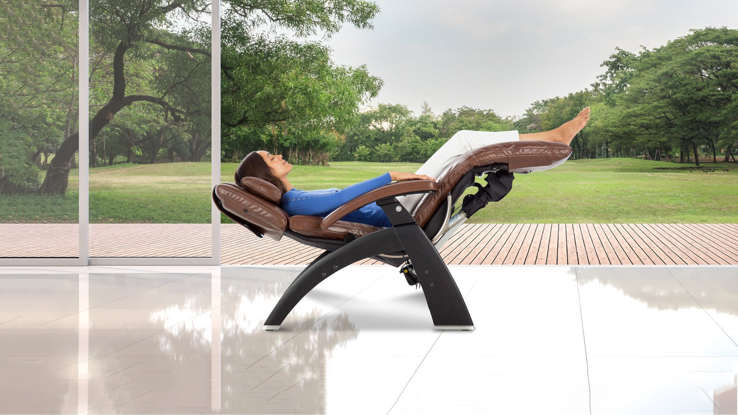 Woman relaxing in zero gravity recliner with brown leather cushions and black arch base with garden view