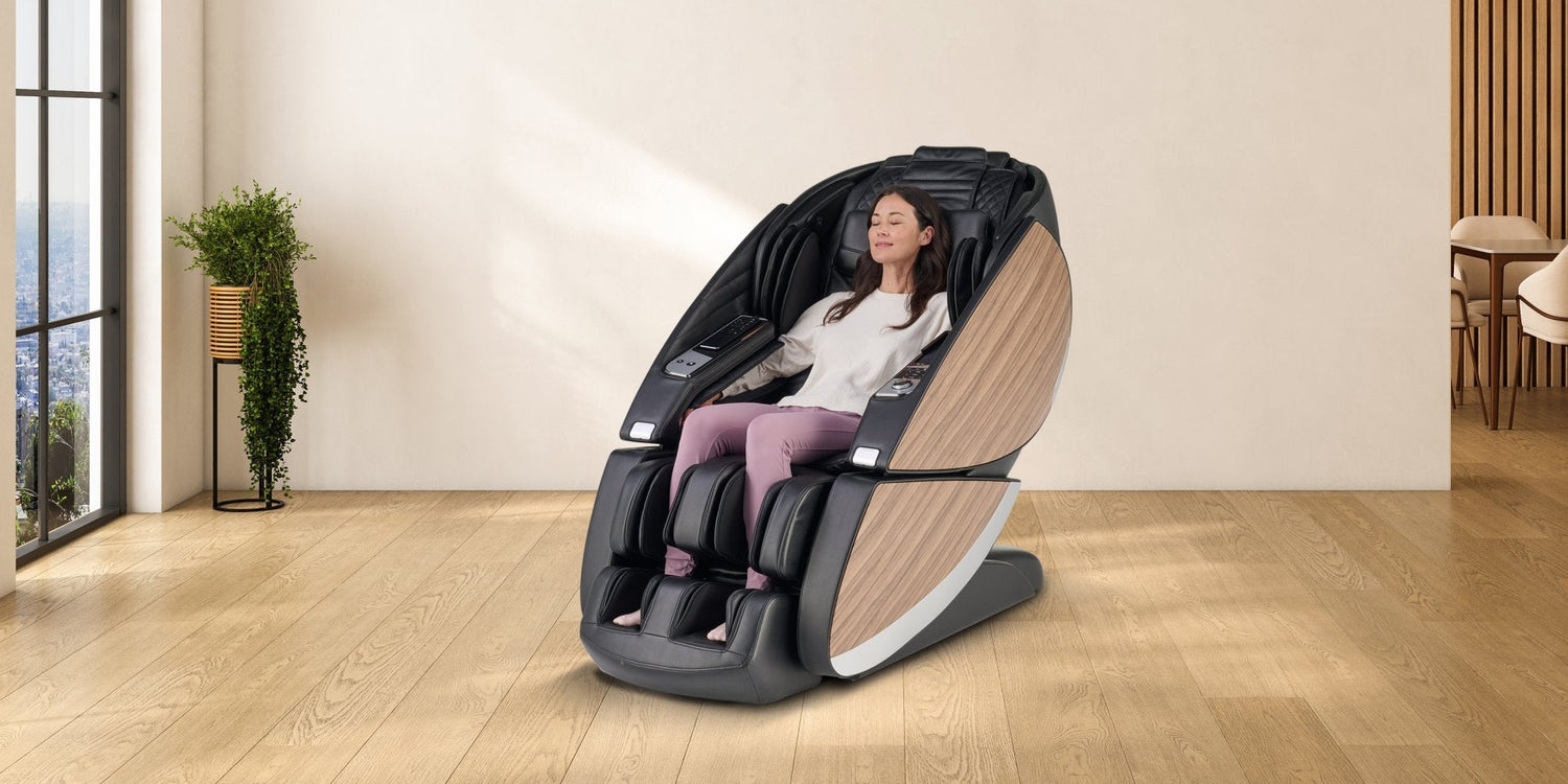 Woman relaxing with eyes closed in black full body massage chair with wood panel accents in modern home