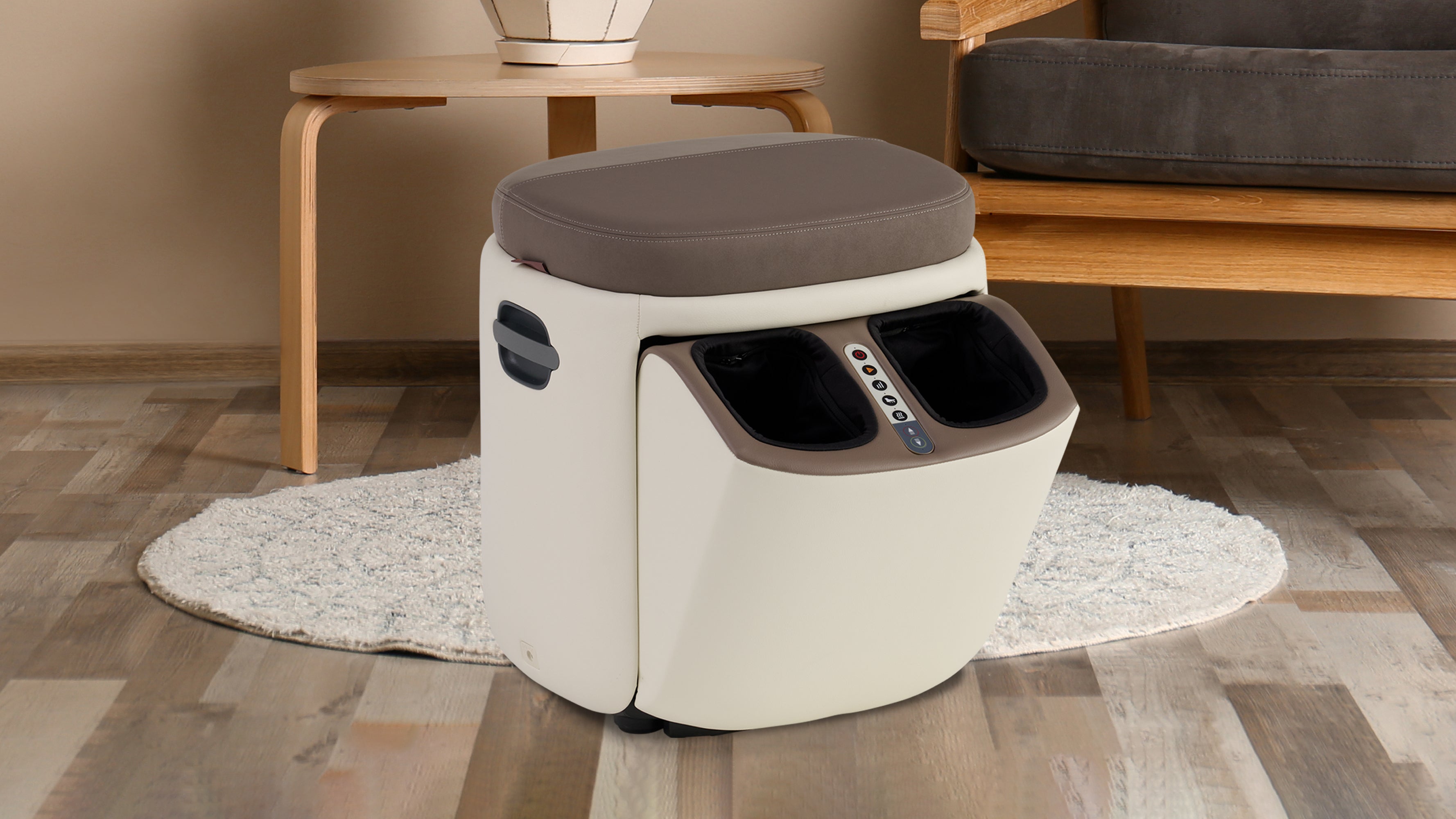 Cream and brown compact electric foot massager with cushioned seat and control panel on wooden floor