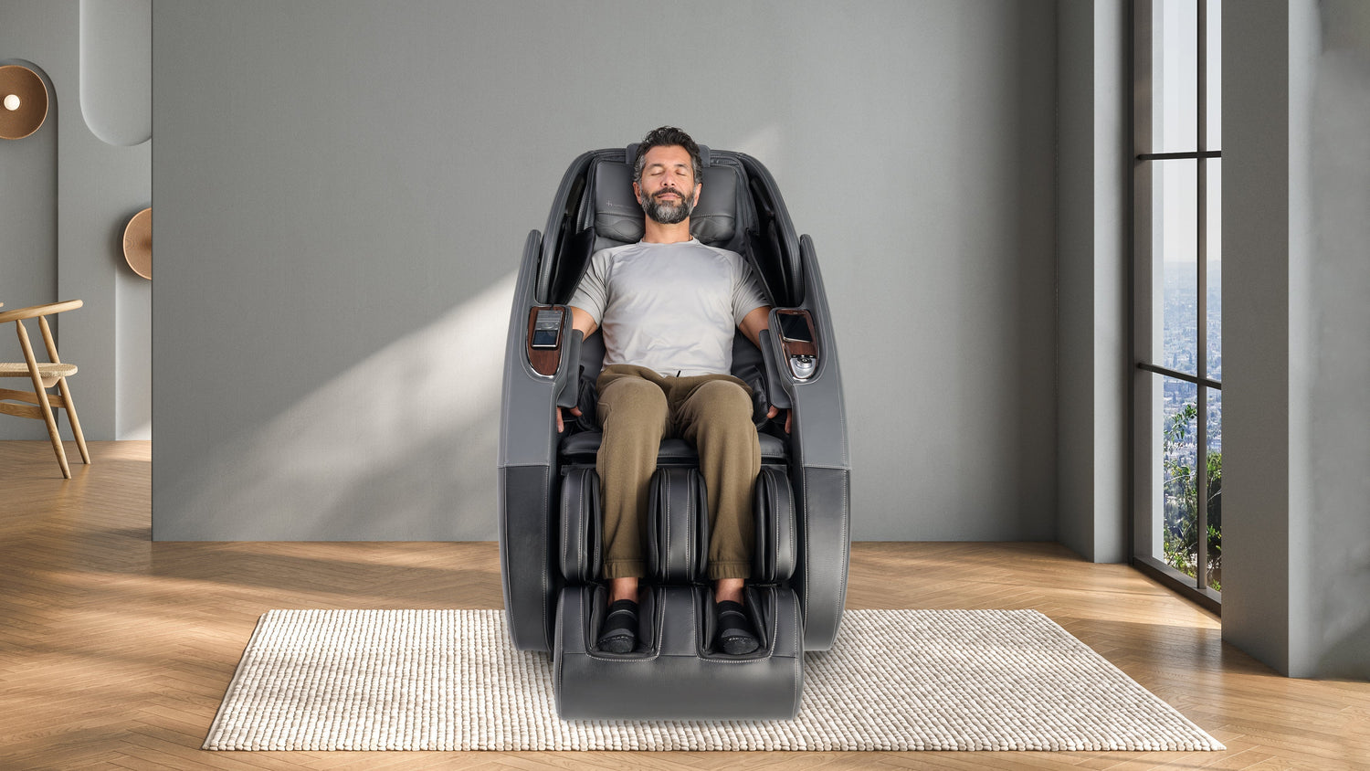Man relaxing in a black massage chair in a modern room