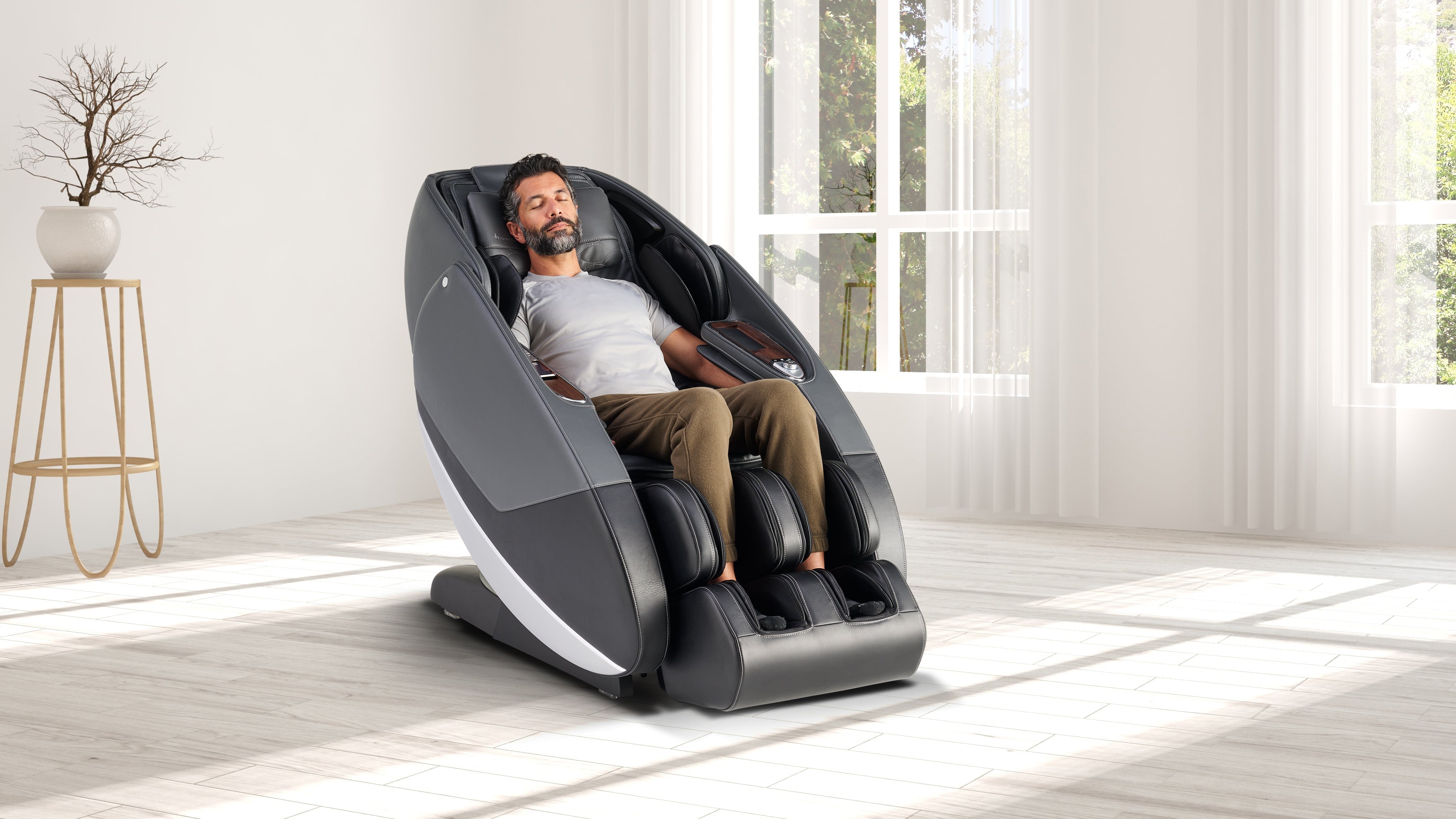 Man relaxing in a Human Touch massage chair designed for deep relaxation and improved sleep quality
