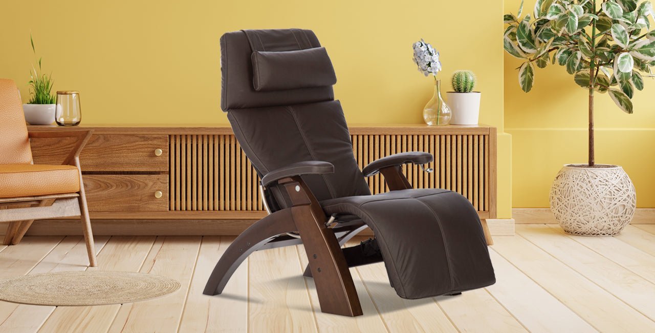 Dark brown leather zero gravity recliner chair with walnut wood base in warm modern living room