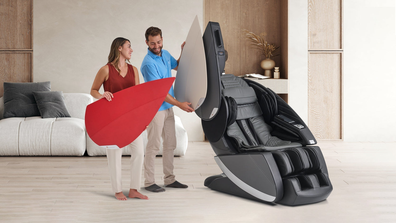 Couple unboxing black and gray full body massage chair with calf foot rollers and touchscreen panel