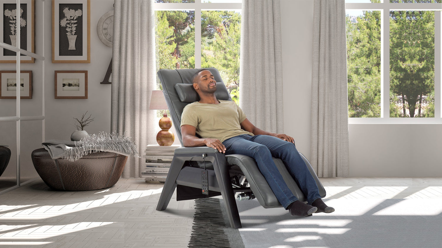 Man relaxing in gray leather zero gravity recliner chair with gray wooden frame in bright living room near window