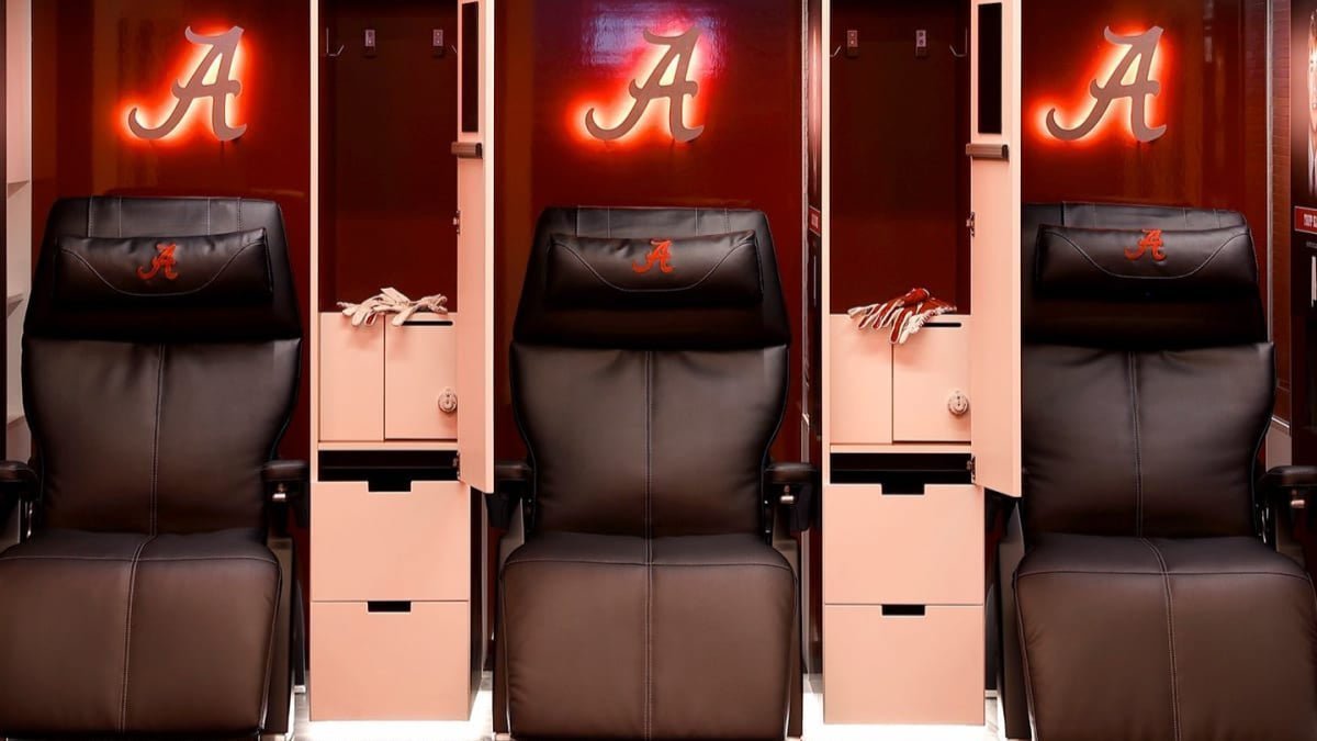 Human Touch Perfect Chair zero gravity recliners inside the Alabama Crimson Tide football locker room for athlete recovery and relaxation