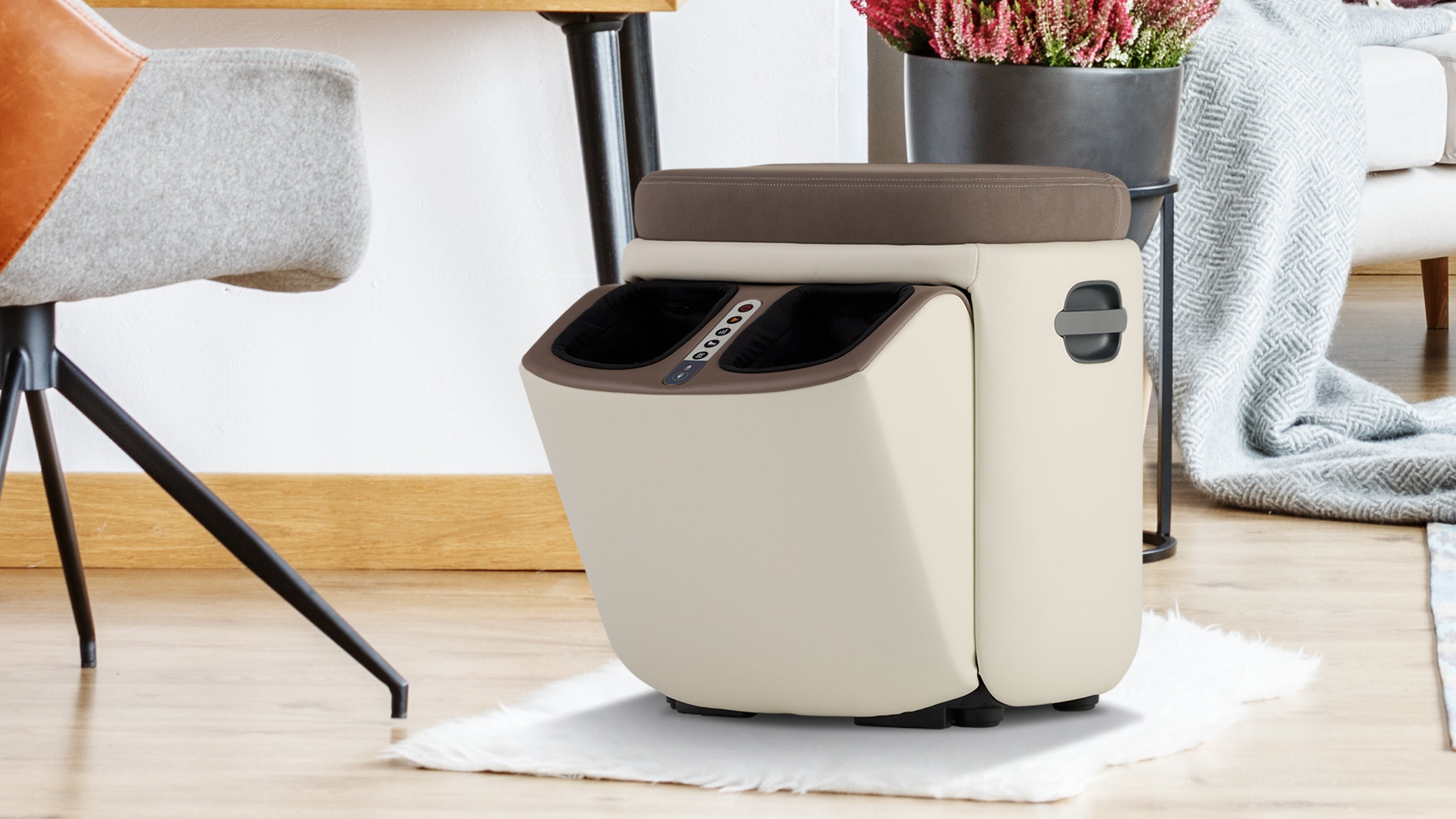 Cream and brown electric foot massager with built-in controls and cushioned seat on wooden floor