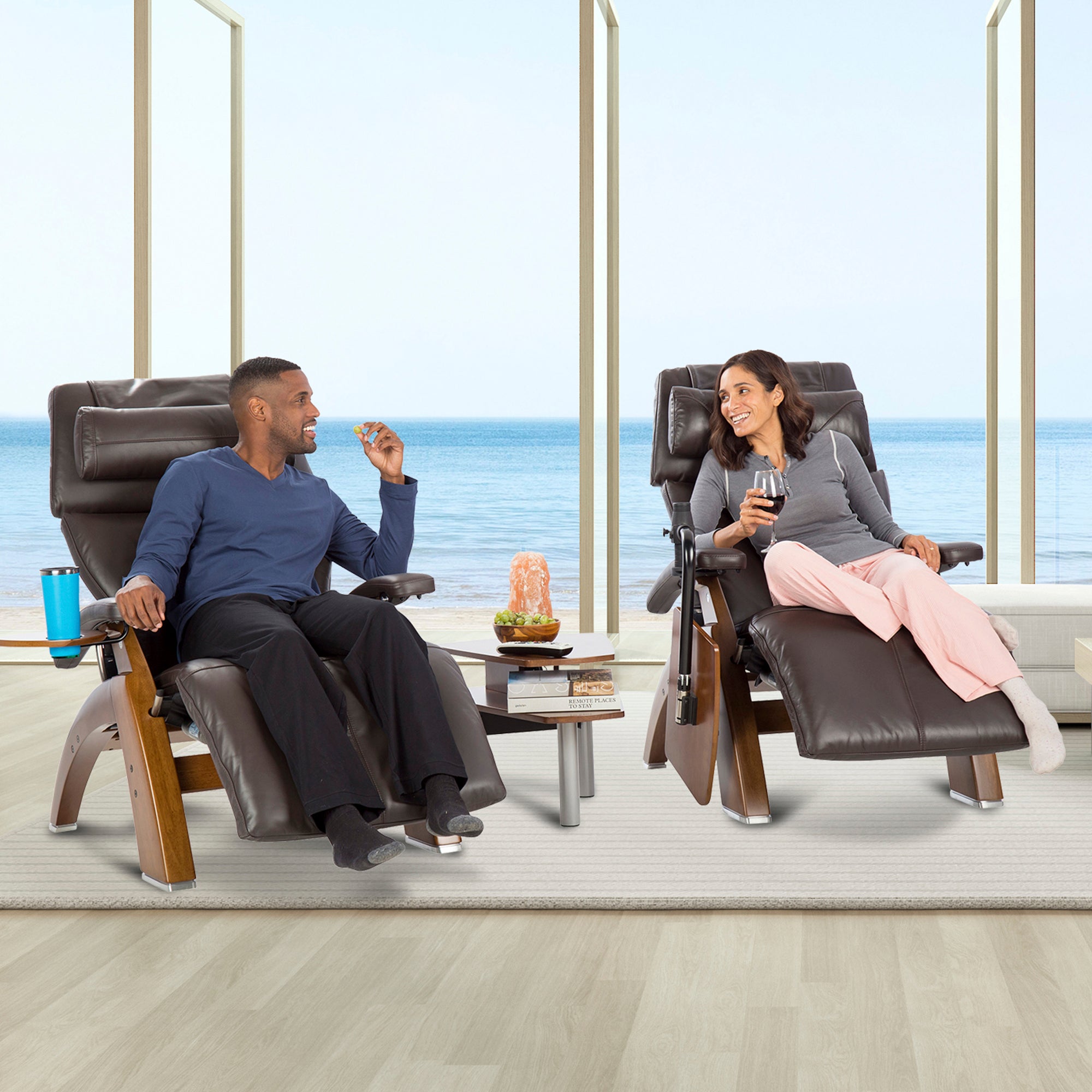Perfect Chair Accessory Table shown between two recliners by oceanfront window, holding drinks and snacks for relaxing couple