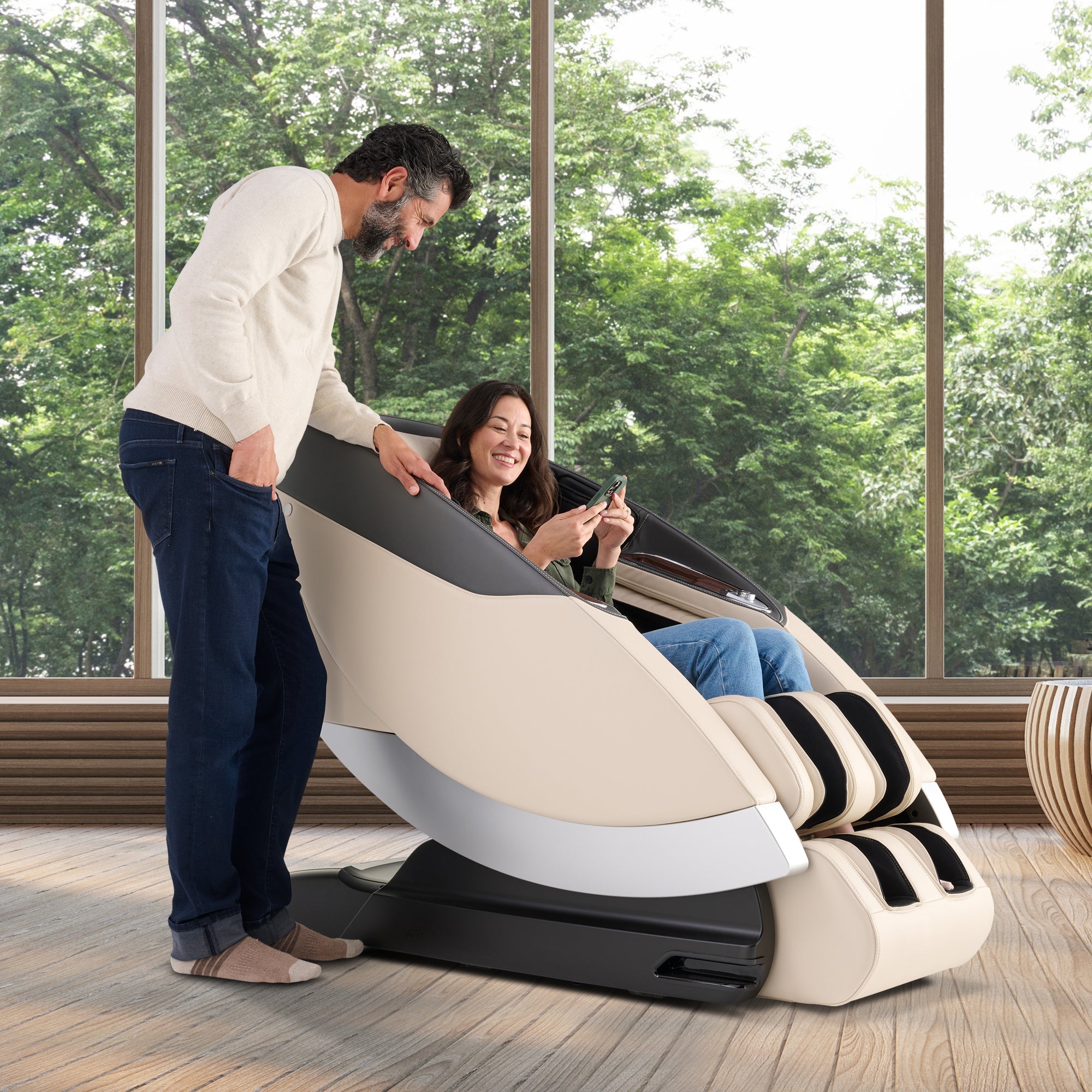 Super Novo 2.0 massage chair demonstrated with person enjoying features while another person shows controls