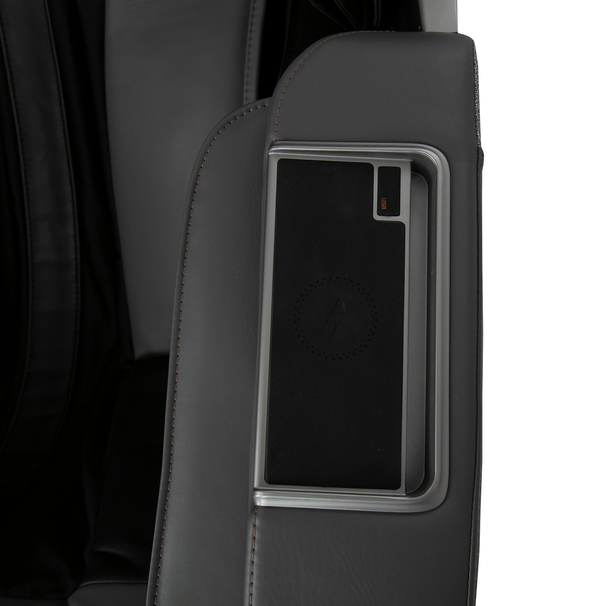 WholeBody ROVE massage chair side panel with sleek charging dock integrated into dark leather armrest