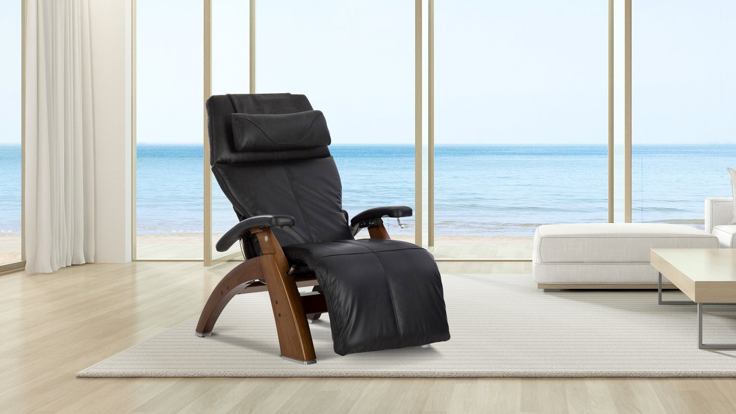 Black leather zero gravity recliner with walnut wood curved frame and headrest by ocean view window
