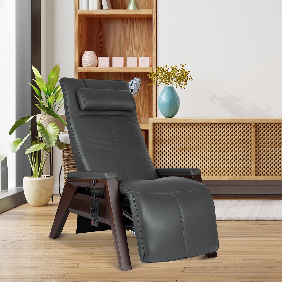 Gravis ZG Chair in gray leather, shown in modern living room with wooden shelving and indoor plants