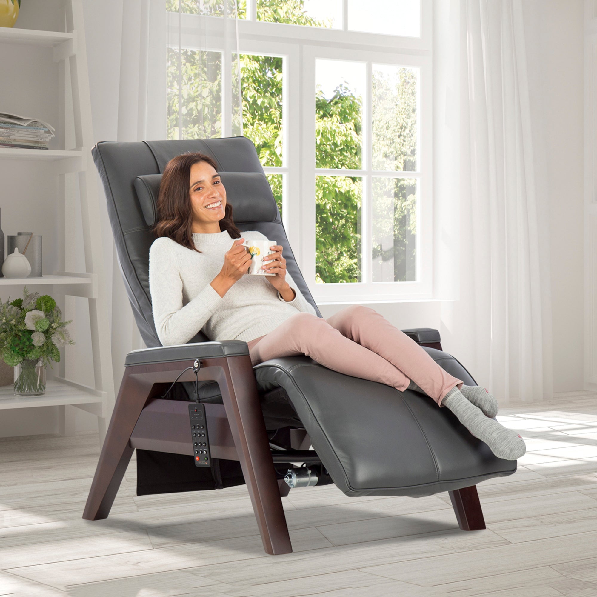 Gravis ZG Chair shown in relaxed position with modern grey upholstery and wooden base in bright sunny living room setting