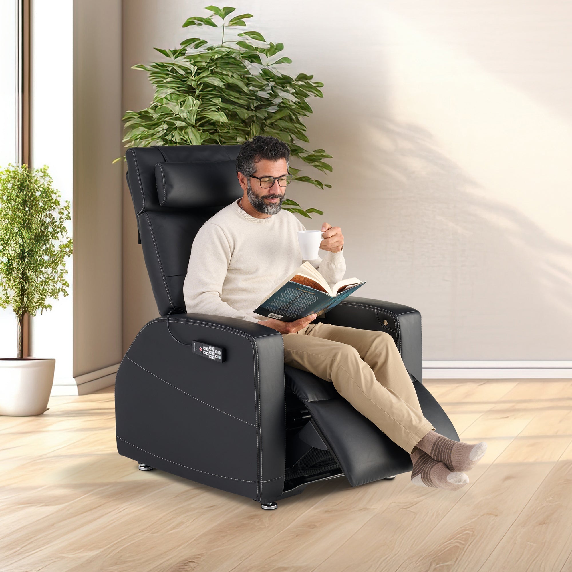 Laevo ZG Chair with Lift Assist shown in black leather, featuring person reading book in comfortable reclined position