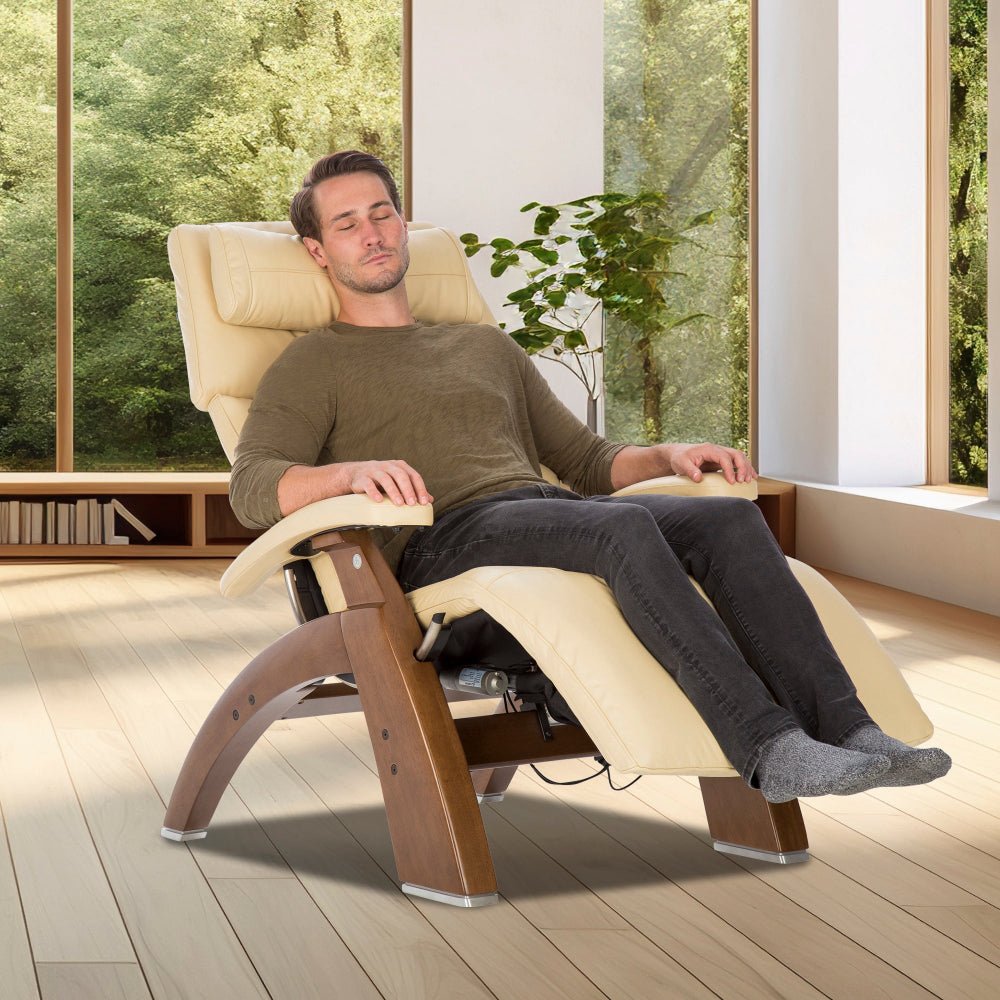 Person relaxing in Perfect Chair PC-610 Omni-Motion Classic recliner in zero-gravity position near sunny window
