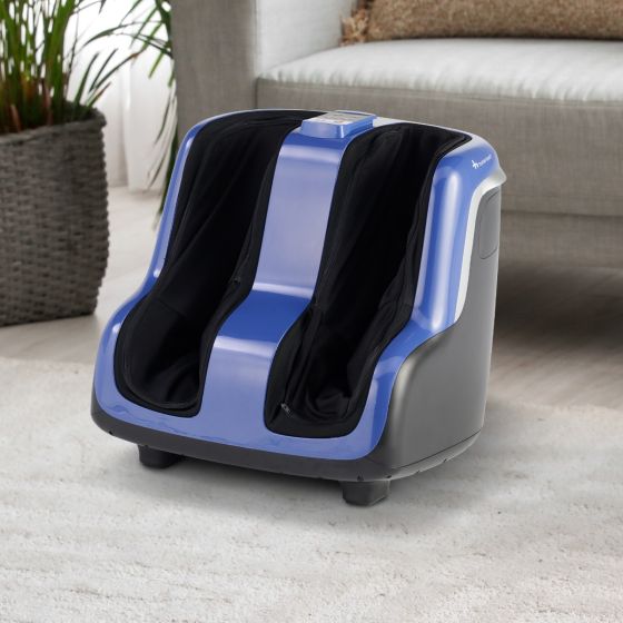 Reflex SOL Plus foot and calf massager with blue accents on gray base, shown on light carpet near sofa and plant