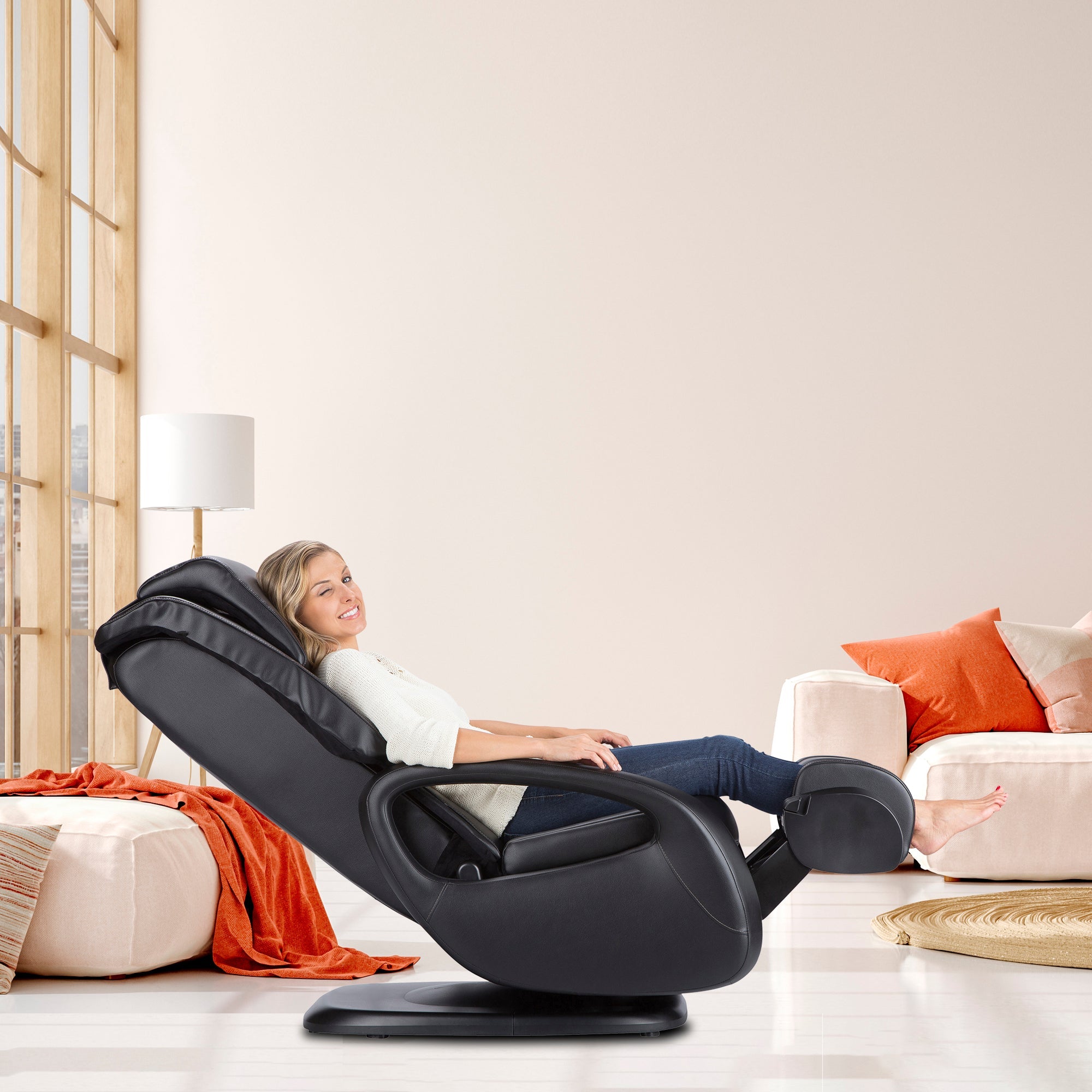 WholeBody 5.1 Massage Chair in black shown in modern living room with person relaxing in reclined position