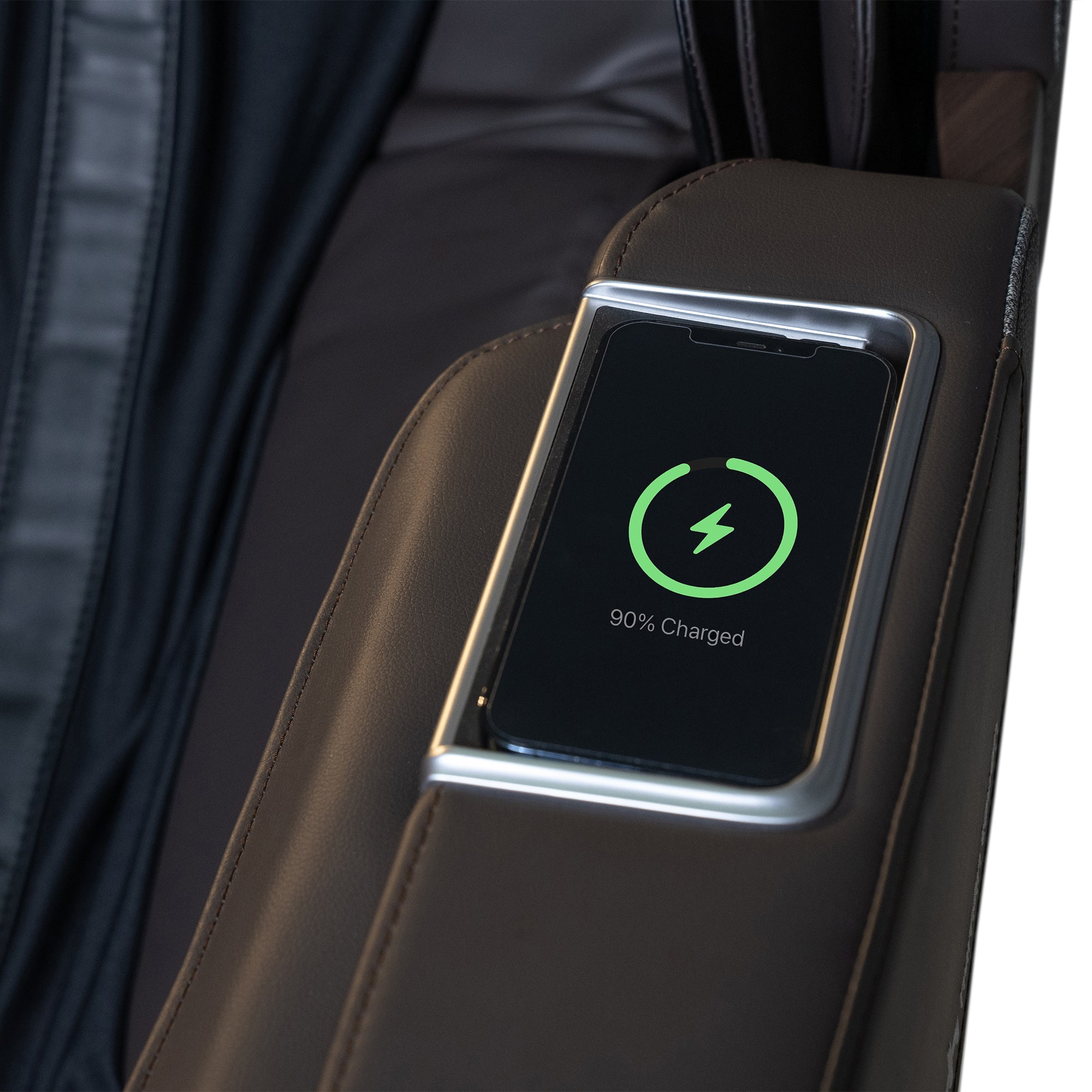 WholeBody ROVE massage chair with wireless charging display panel showing 90% charge status on leather armrest