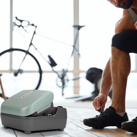 Man taking off his shoes to use the Reflex PopUp Foot Massager
