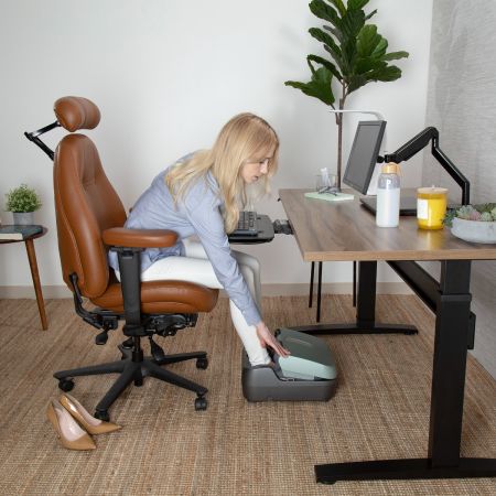 Woman getting ready to use the Reflex PopUp Foot Massager