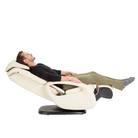 Side view of a man in white WholeBody 5.1 massage chair with ottoman flipped