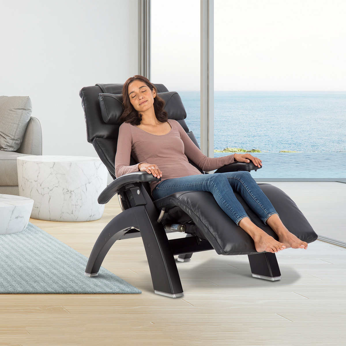 Woman in a Perfect Chair PC-610 in black upholstery with a matte black base